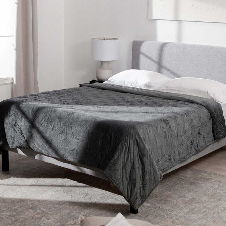 charcoal weighted blanket on bed