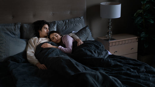 How to increase deep sleep: A couple asleep in bed