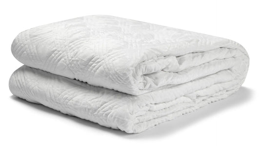 The Hush Classic Blanket With Duvet Cover in white color folded neatly on a white surface.