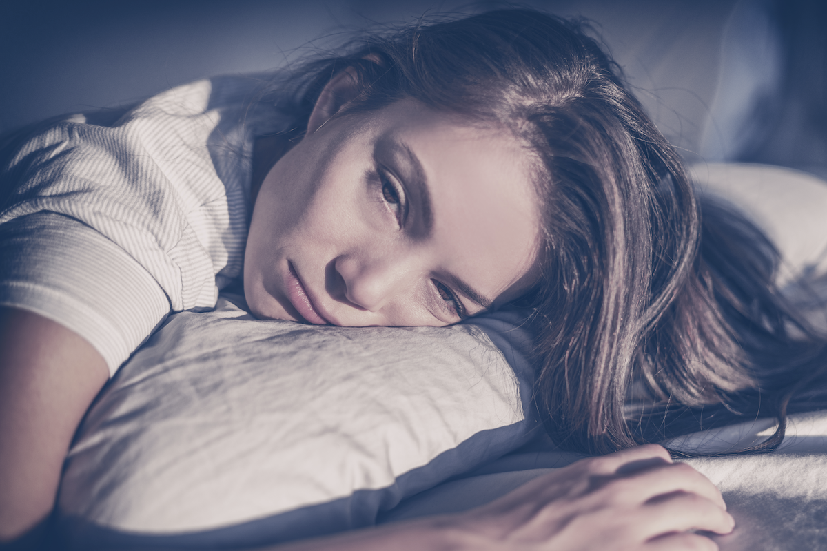 tossing and turning: woman laying in bed