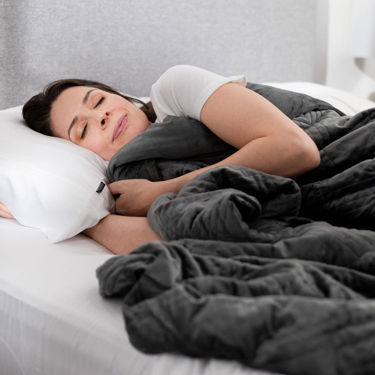 Woman sleeping under charcoal weighted blanket