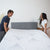 Couple placing Hush Iced Hybrid Mattress on bed frame